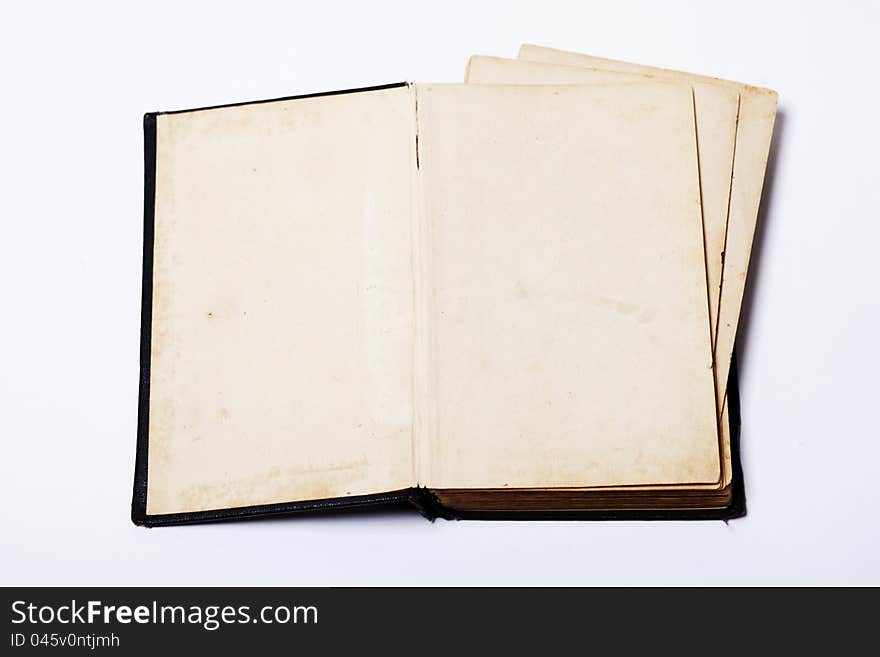 Open old book on white background