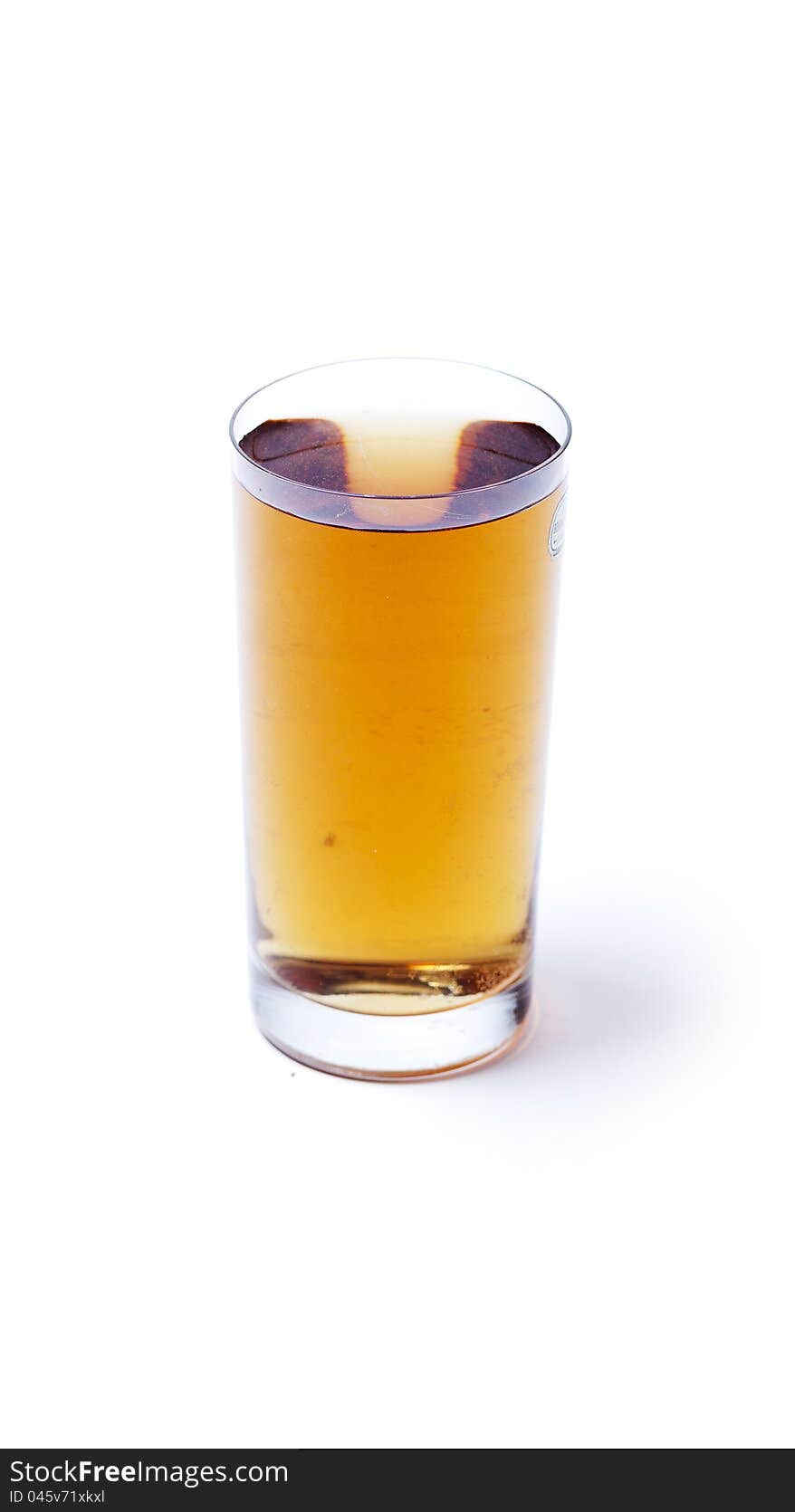 Glass with orange water on white background