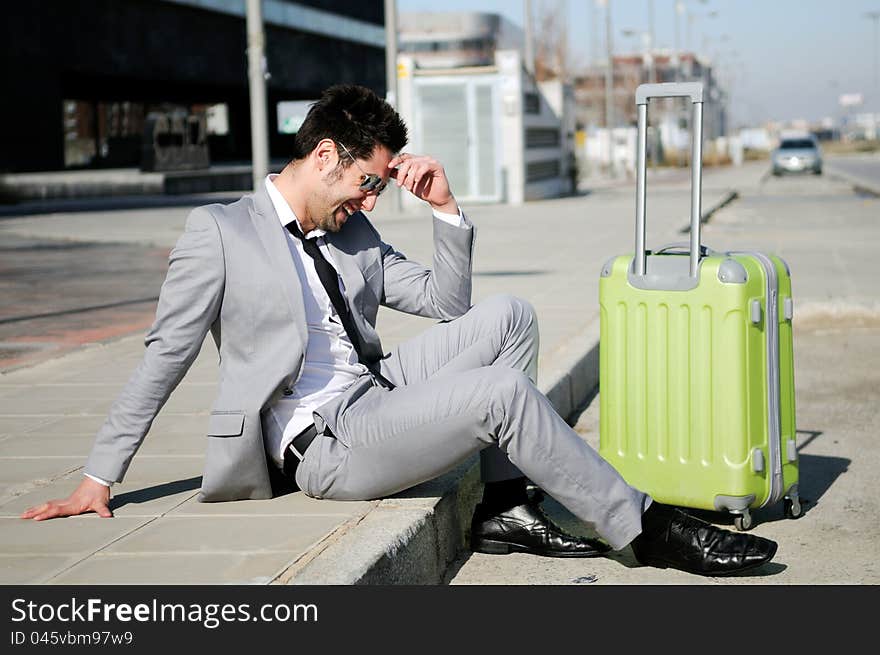 Man dressed in suit with a suitcase