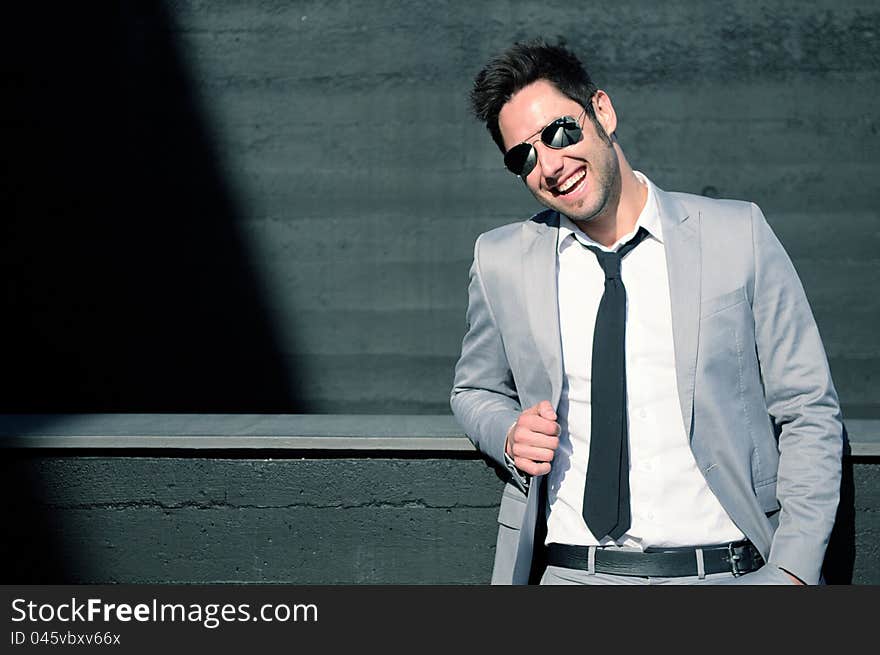 Portrait of a handsome young businessman laughing. Portrait of a handsome young businessman laughing