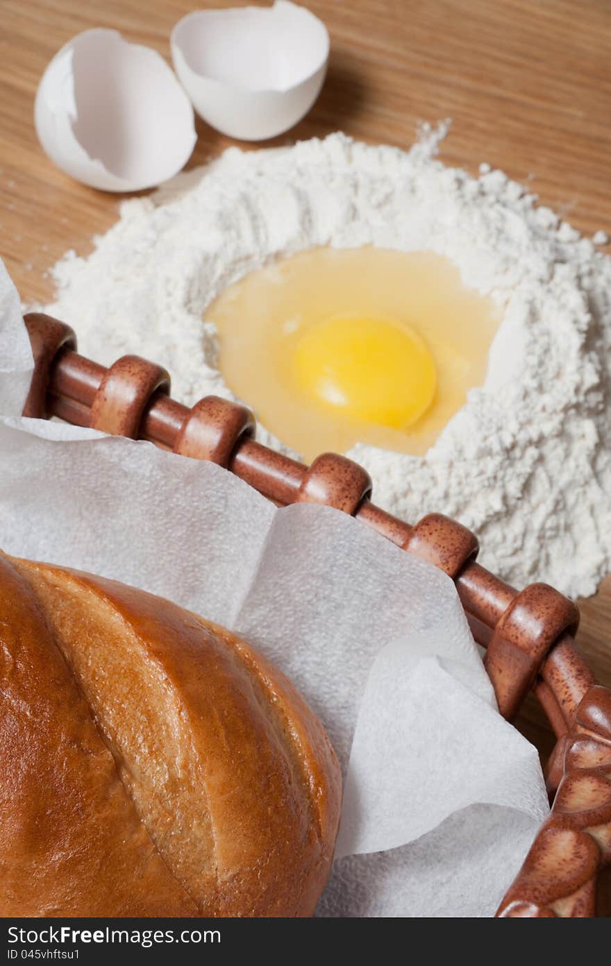 Bread and flour with egg on the wood table