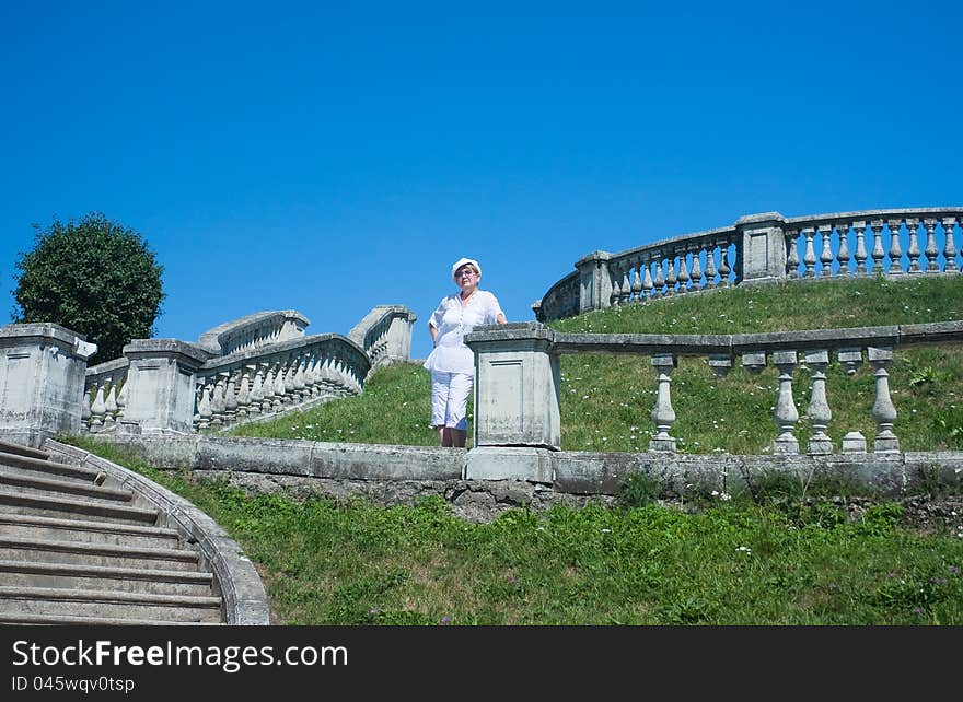 A woman standing on a shaft in the Garden of Venus. Peterhof. Russia. A woman standing on a shaft in the Garden of Venus. Peterhof. Russia