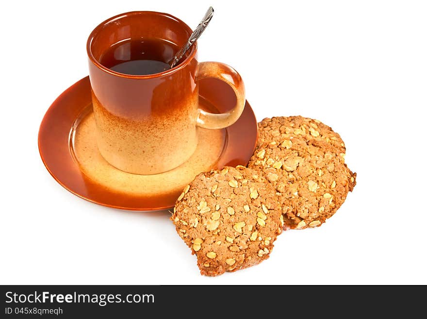 Big brown cup of tea and oatmeal cookies with peanut on a white background.