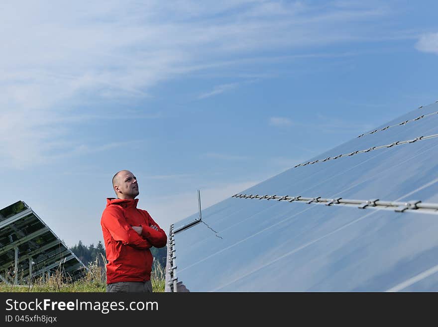 Engineer Using Laptop At Solar Panels Plant Field