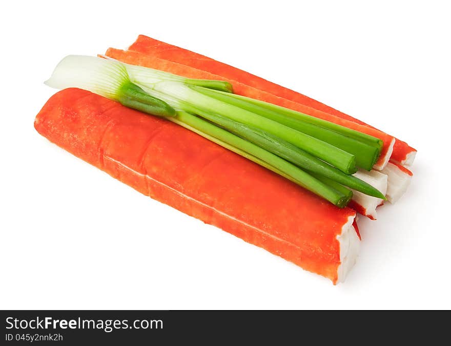 Crab sticks and spring onion against white background