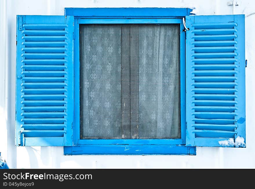 Blue window on white wall on a ship