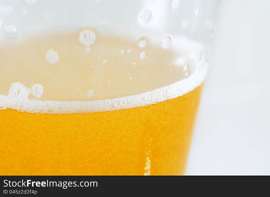 Macro shot of a foaming cold beer ready to drink