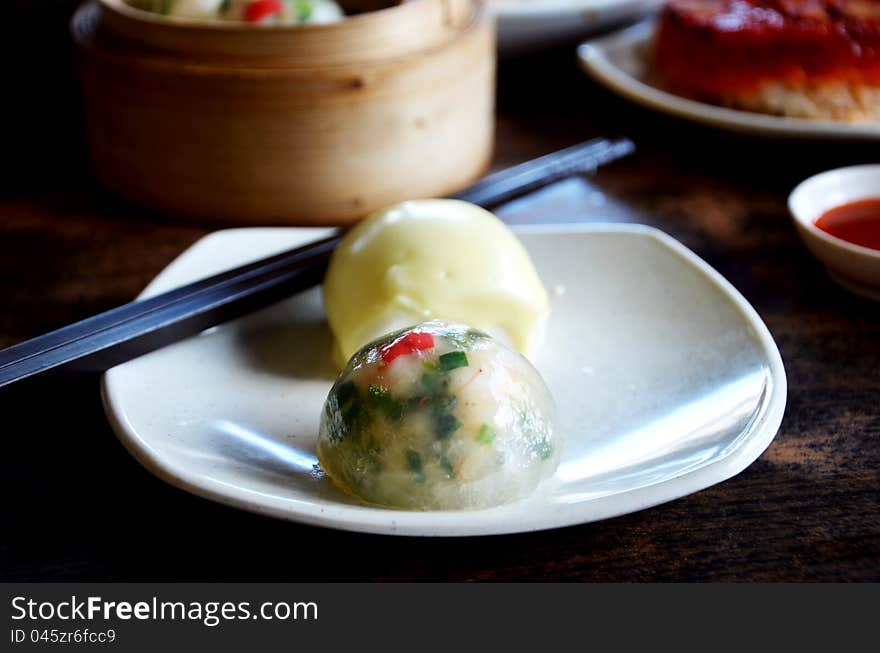 Crystal chives dumpling and  mini buns  on dish. Crystal chives dumpling and  mini buns  on dish