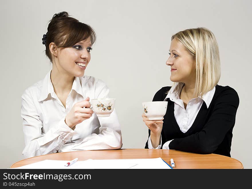 Beautiful girls smiling drink tea sit in the office