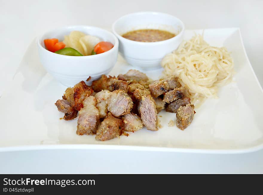 Grilled pork served with sweet sauce and vegetable , noodle. Grilled pork served with sweet sauce and vegetable , noodle