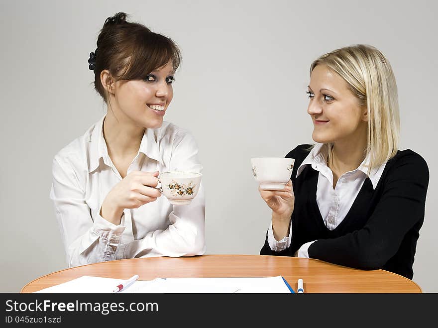 Beautiful girls smiling drink tea