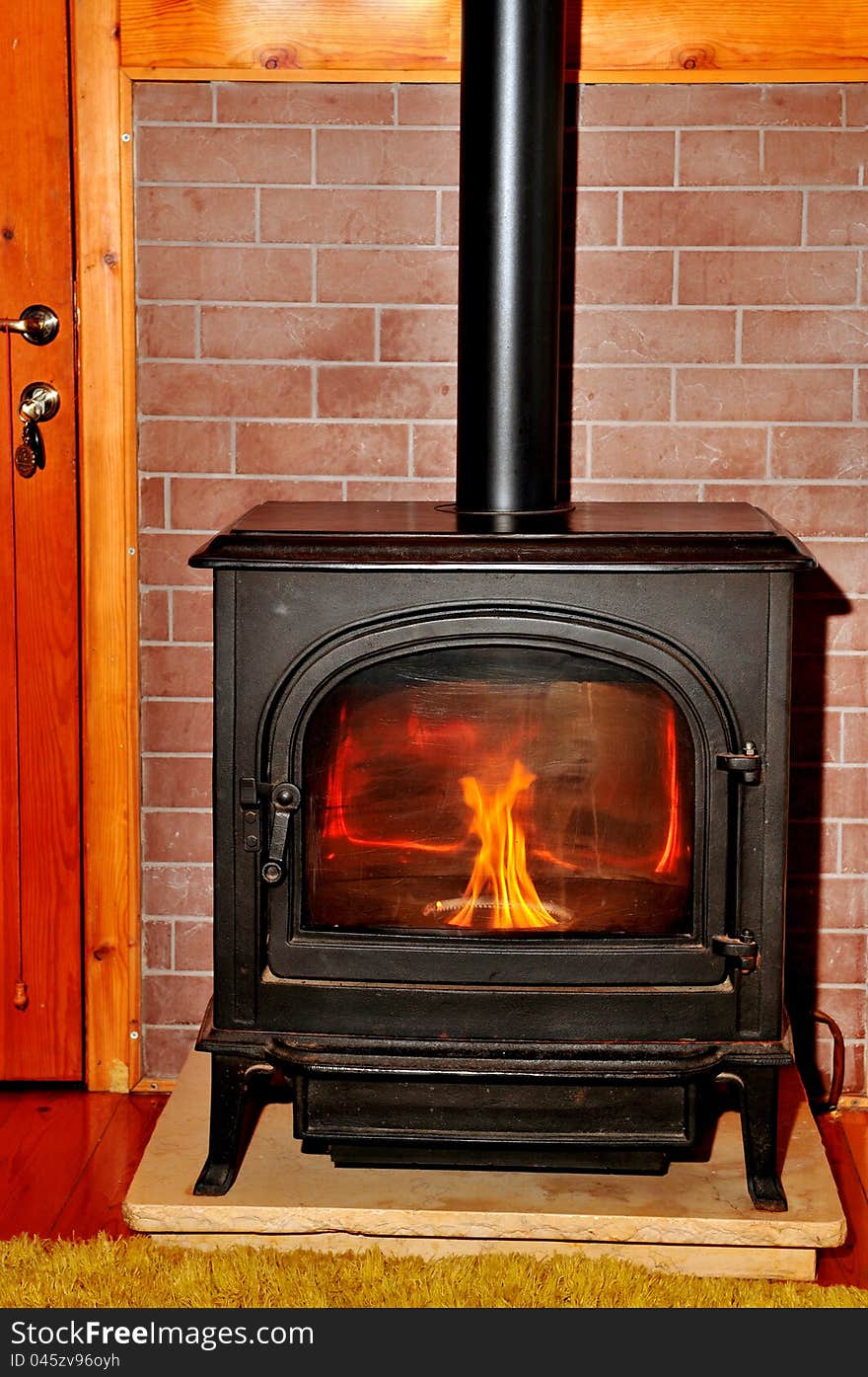 Detail of the interior metal fireplace that heats a small room. Detail of the interior metal fireplace that heats a small room