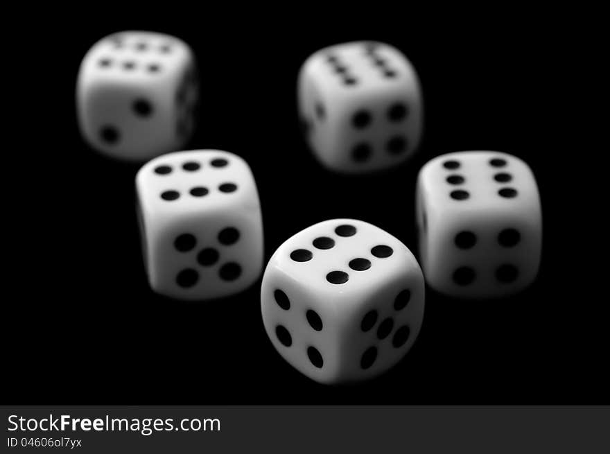 Five dice on black background