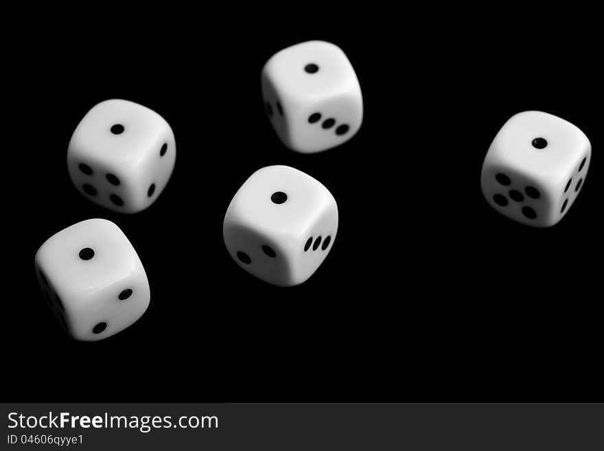 Five dice on black background