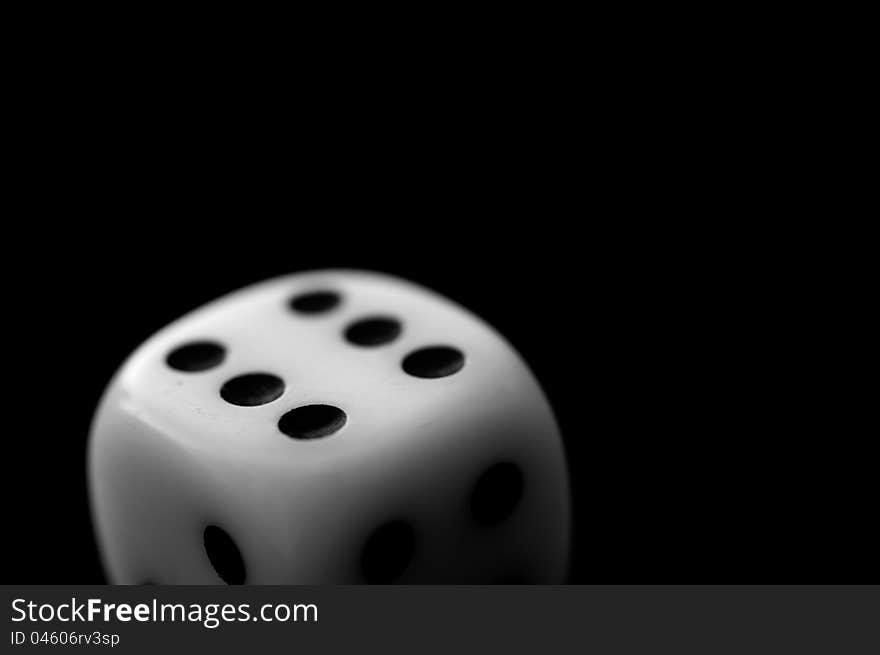A dice on black background