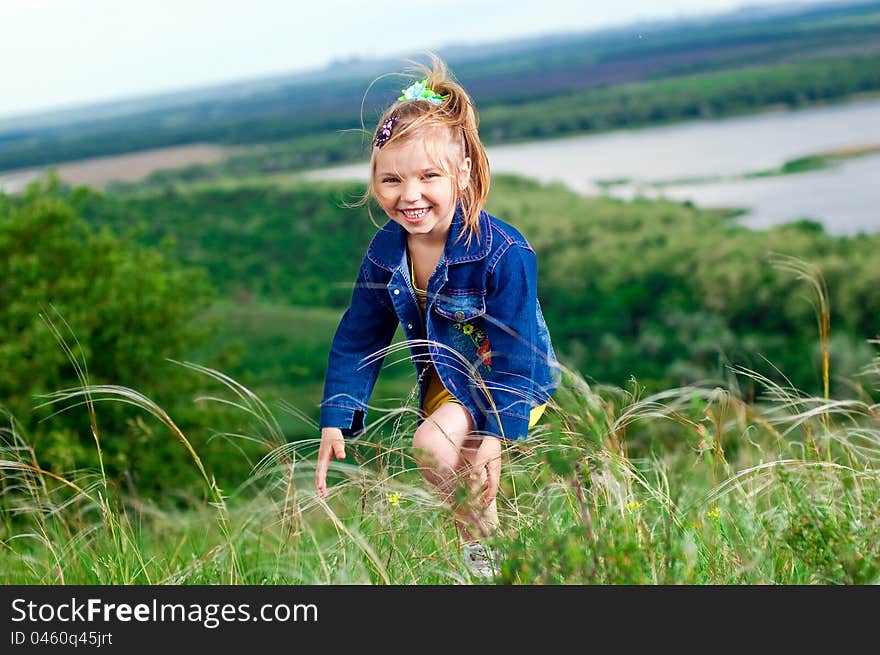 Beautiful little girl in jean clothes on a walk outdoors. Beautiful little girl in jean clothes on a walk outdoors