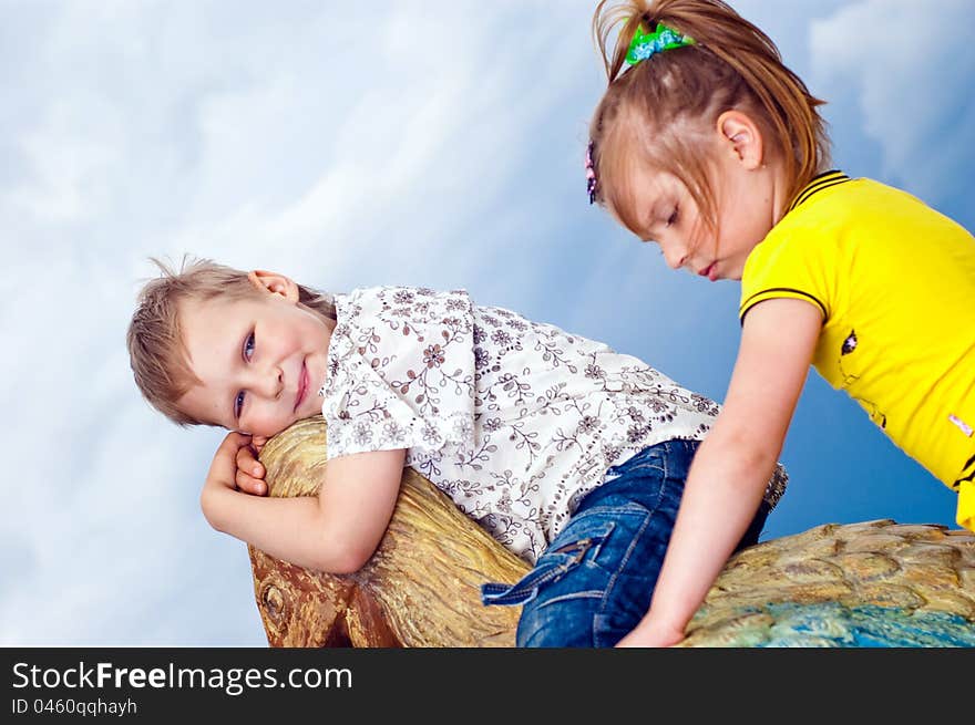 Little girl and boy on a background sky