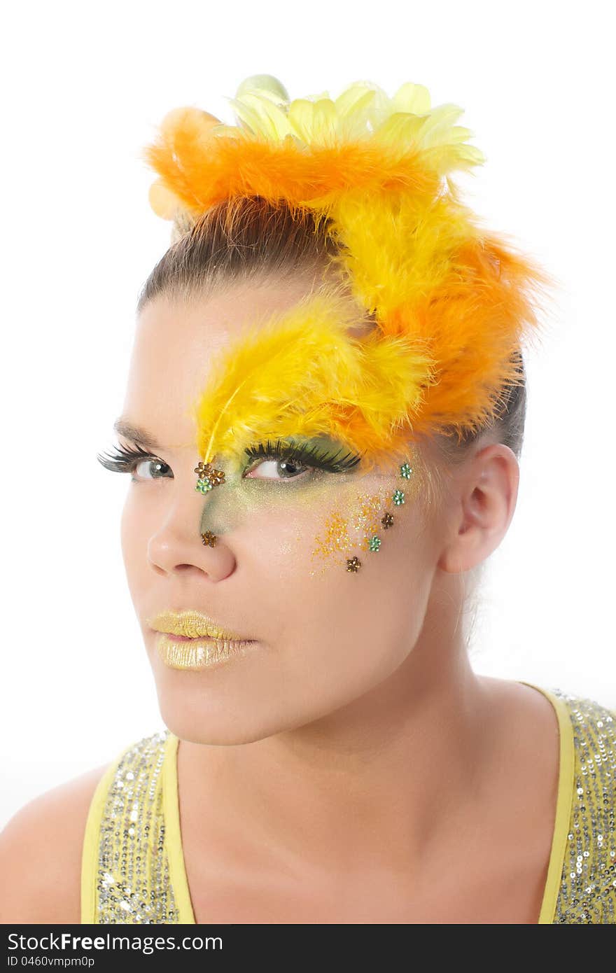 Picture of an easter girl dressed in yellow, with eggs in her hair looking into the camera, on a white, isolated background