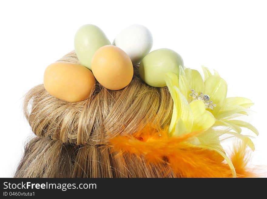 Picture of a girls hair formed as a nest, with easter eggs in it, on a white, isolated background. Picture of a girls hair formed as a nest, with easter eggs in it, on a white, isolated background