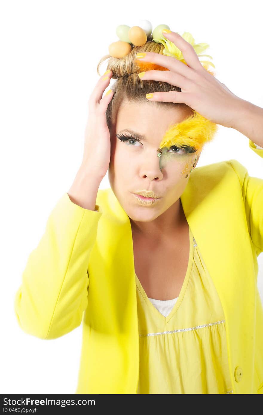 Picture of an easter girl dressed in yellow, with eggs in her hair, on a white, isolated background