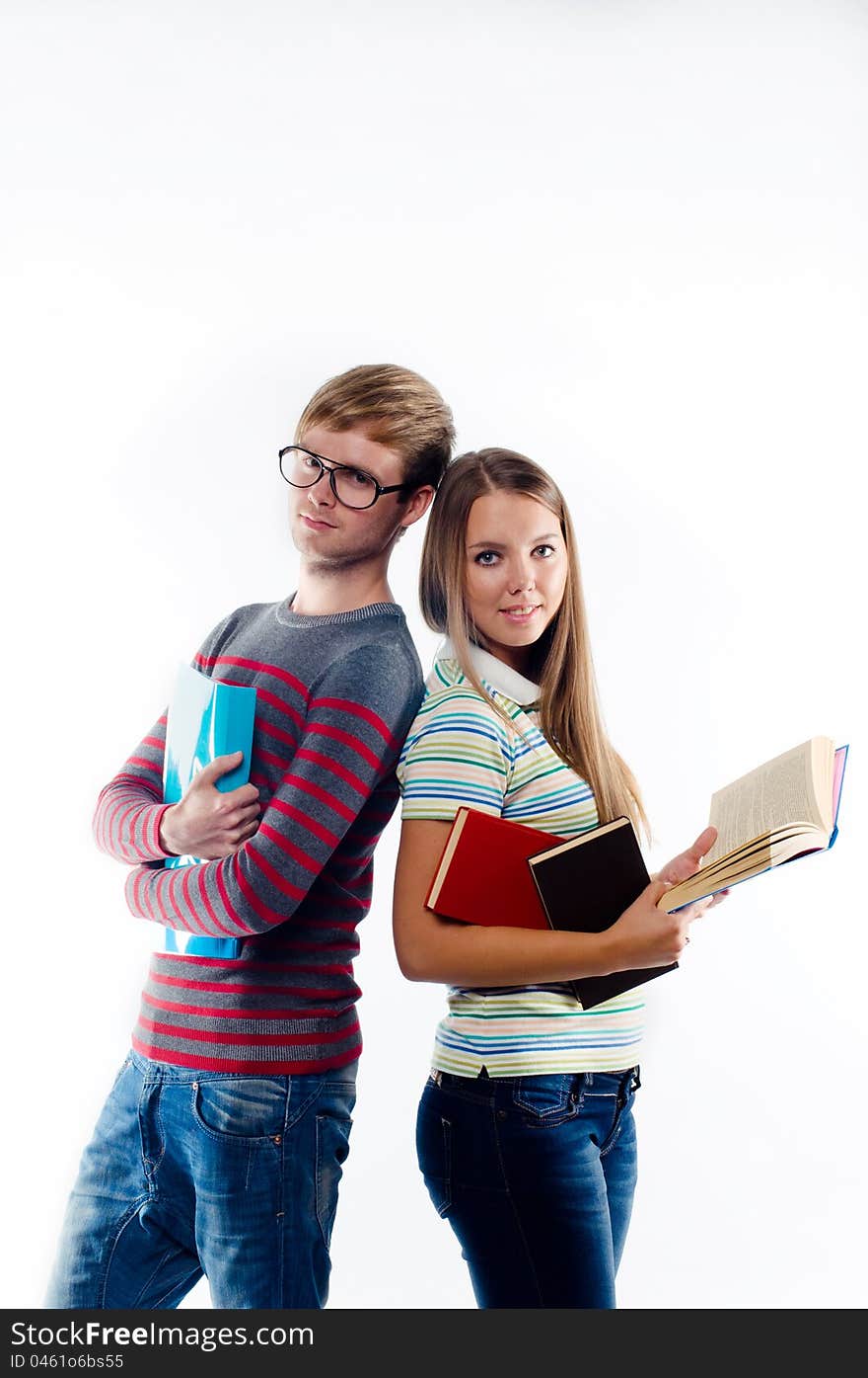 Male and female students standing back to back, on white