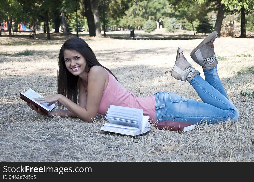 Young woman lying on the grass photographed in park. Young woman lying on the grass photographed in park