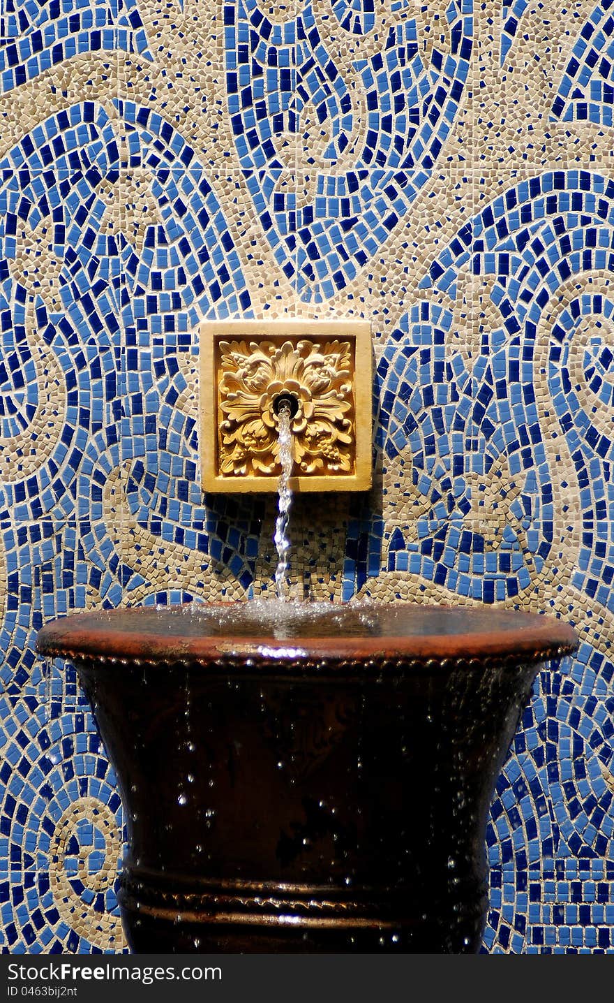 Water fountain on abstract pattern wall