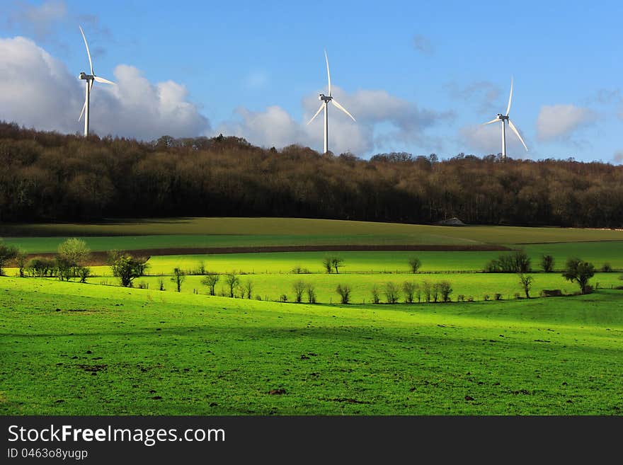 Electrical power generating wind turbines on a beautiful landscape. Electrical power generating wind turbines on a beautiful landscape.