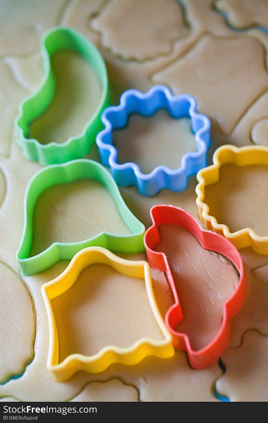 A rolled out dough for biscuits with cookie cutters. A rolled out dough for biscuits with cookie cutters