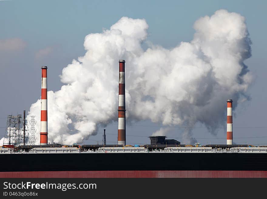 Air polluting smokestack with white smoke