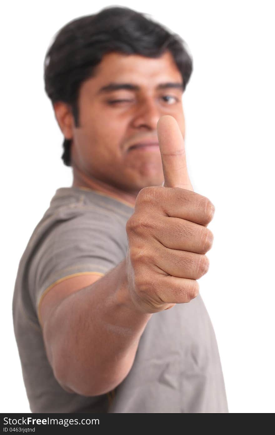 Portrait of happy young Indian giving thumbs up over white background