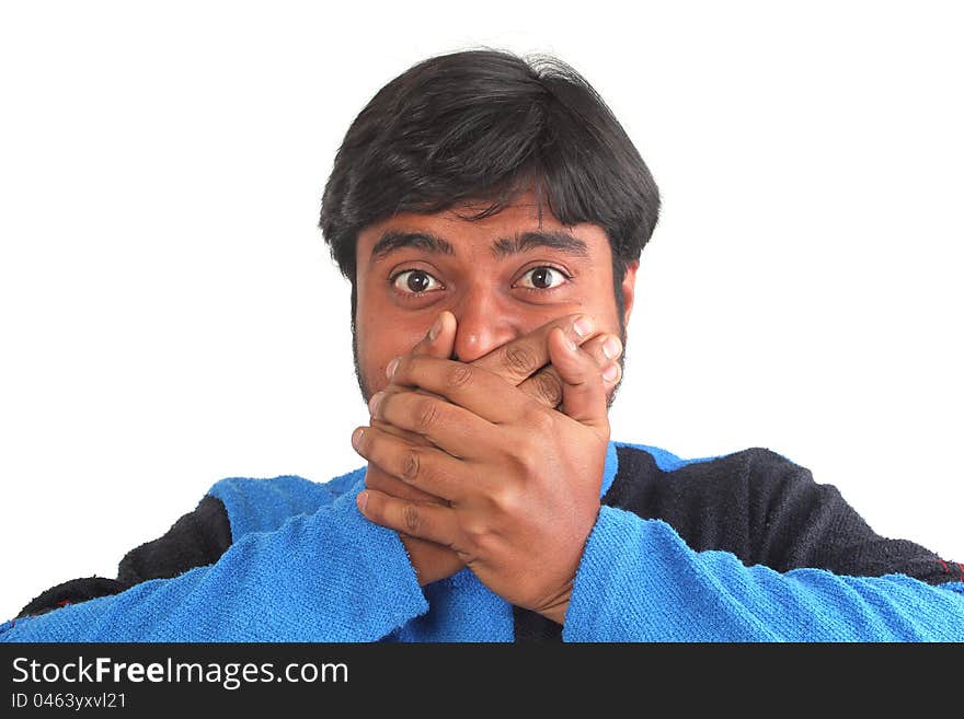 Young south indian youth holding his mouth with hands showing facial expression of disbelief or surprise. Young south indian youth holding his mouth with hands showing facial expression of disbelief or surprise