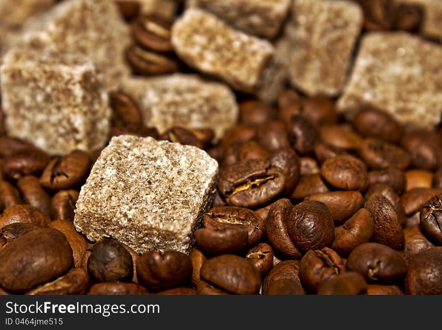 Grains of coffee and pieces of reed sugar. Grains of coffee and pieces of reed sugar