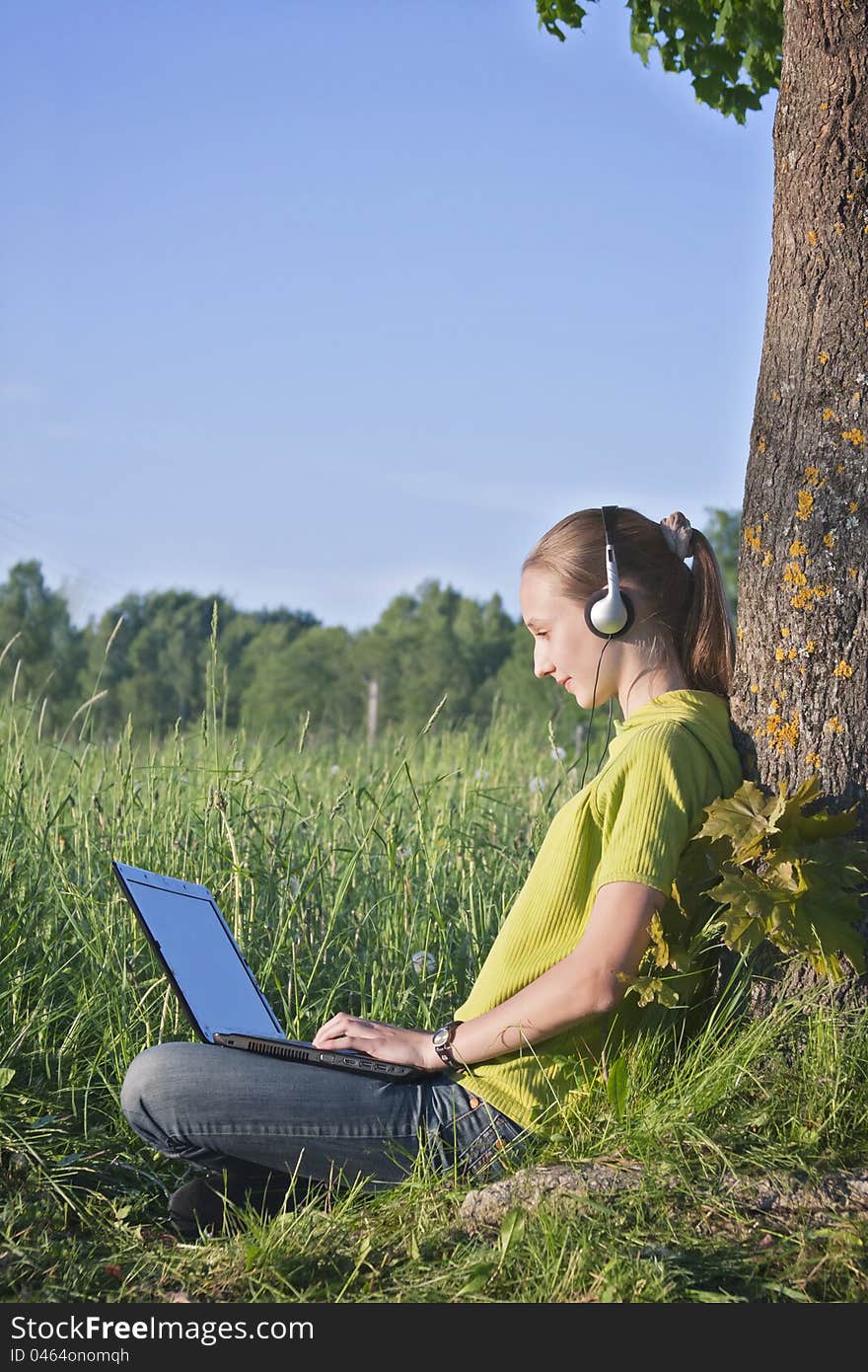 Girl with laptop in the country