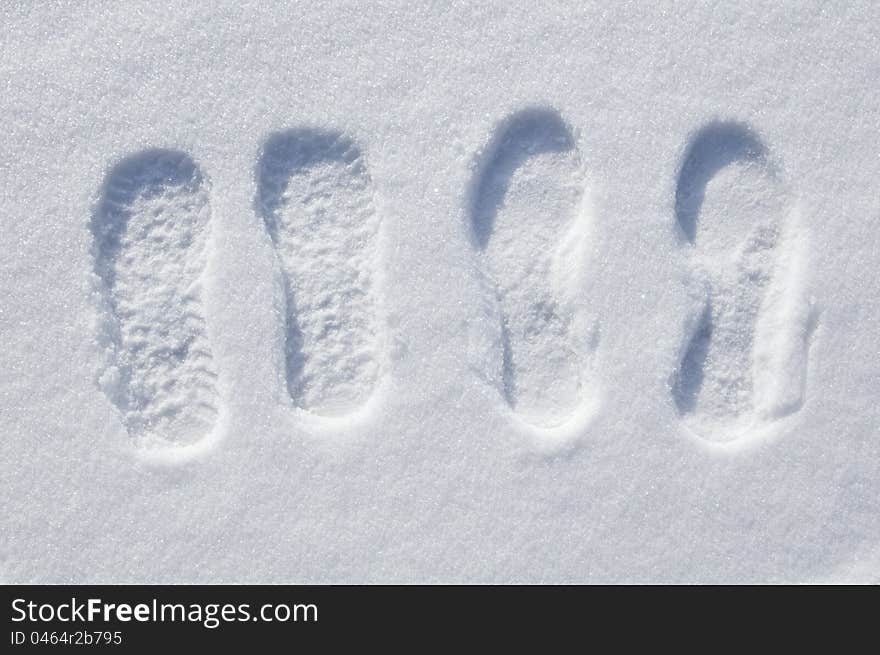 Tracks of man and woman on to snow. Tracks of man and woman on to snow