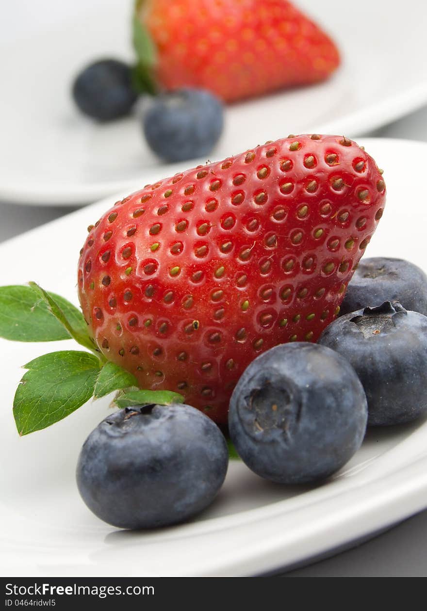 Red strawberry and blue blueberries. Red strawberry and blue blueberries.