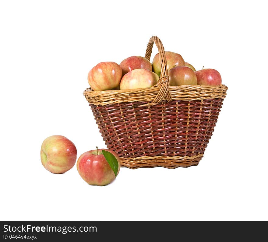 Basket with apples and two apples of lying alongside. Basket with apples and two apples of lying alongside