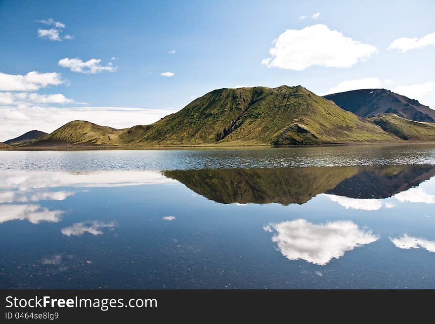 Mountains reflectng in the lake, clouds