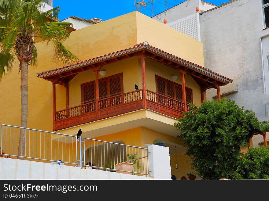 Orange building with the balcony, crows