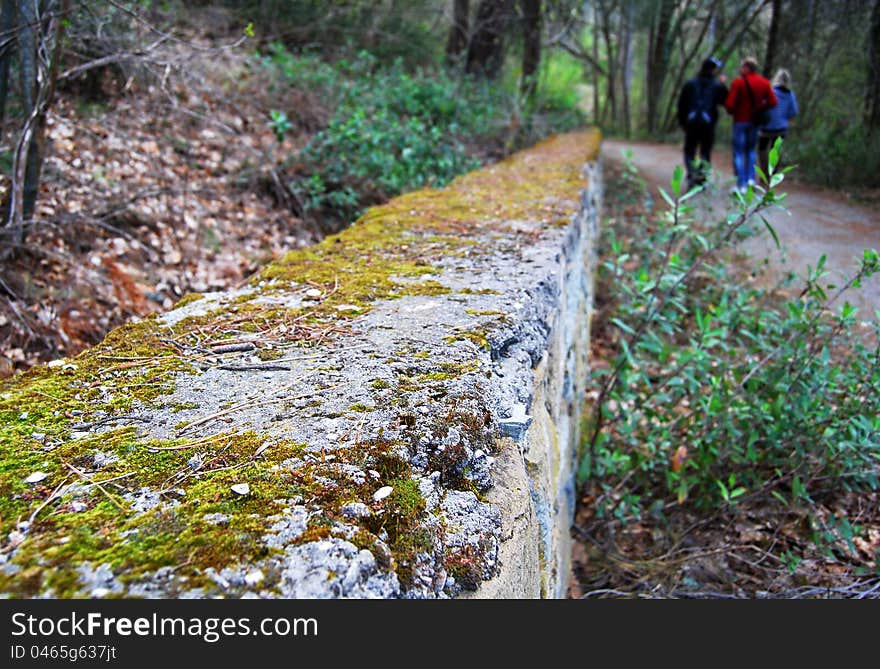 Closeup view on old stone wall at the autumn park alley. Closeup view on old stone wall at the autumn park alley