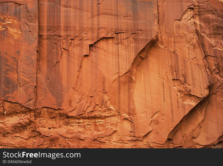 A massive wall of sandstone exhibits stains and various textures in southern Utah. A massive wall of sandstone exhibits stains and various textures in southern Utah.