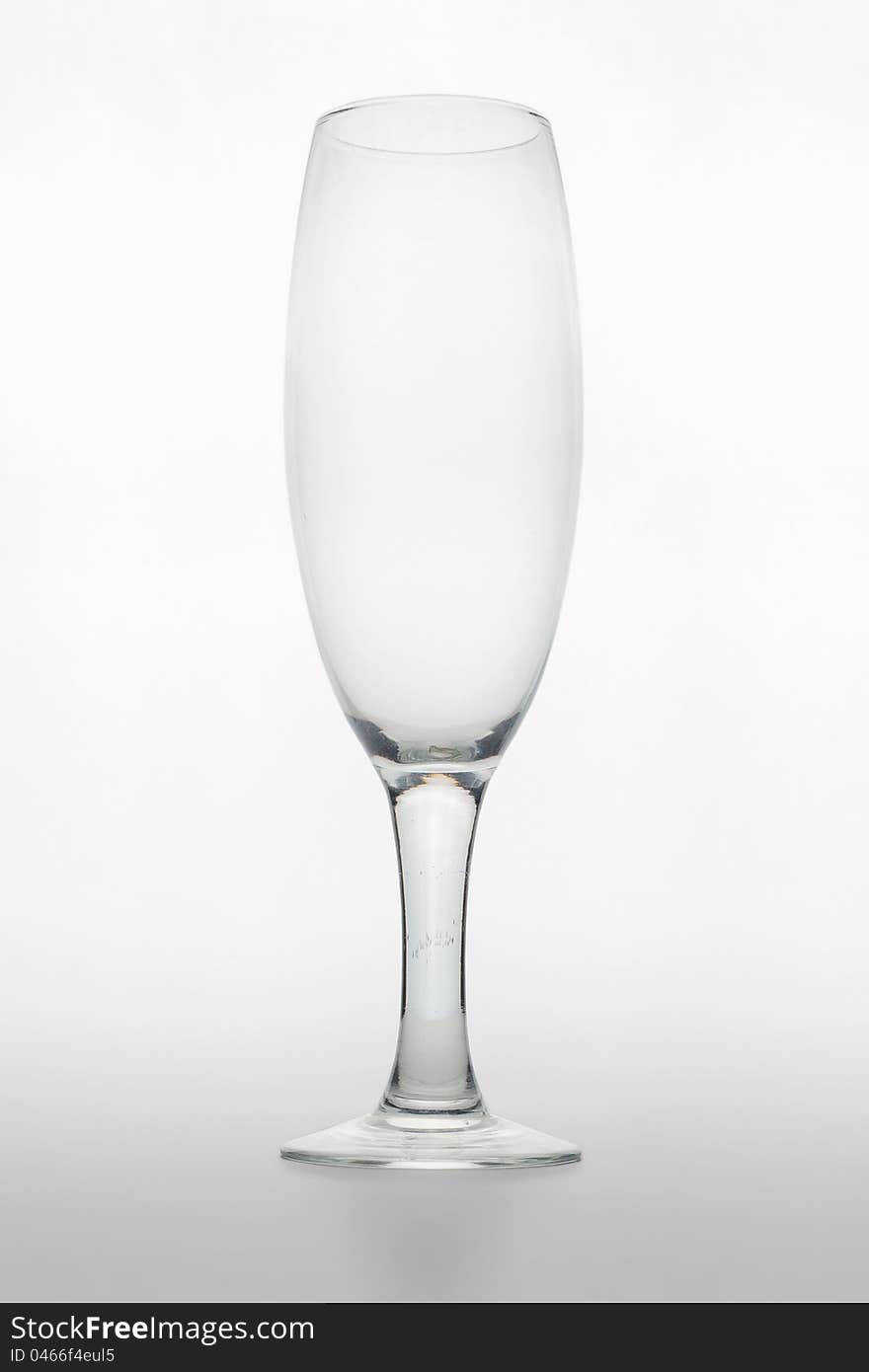 Studio shot of an empty glass for champagne on white matte background with shadow. Studio shot of an empty glass for champagne on white matte background with shadow