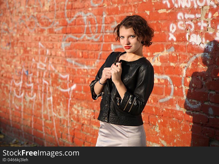 Young girl near the wall