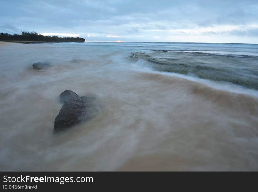 Lava rock on beach before sunrise on Kauai south shore. Lava rock on beach before sunrise on Kauai south shore