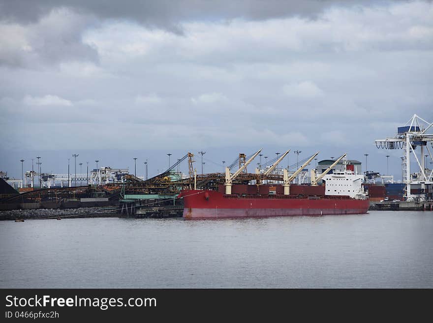 Cargo ship loading, unloading at a port