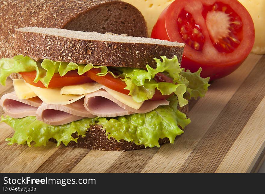 Healthy ham sandwich with cheese, tomatoes and lettuce