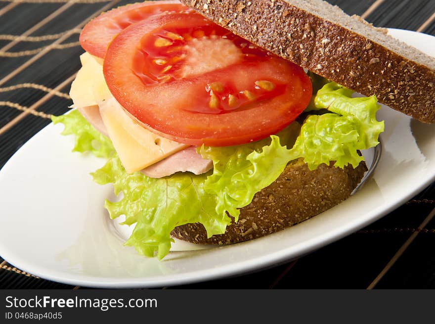 Healthy ham sandwich with cheese, tomatoes and lettuce