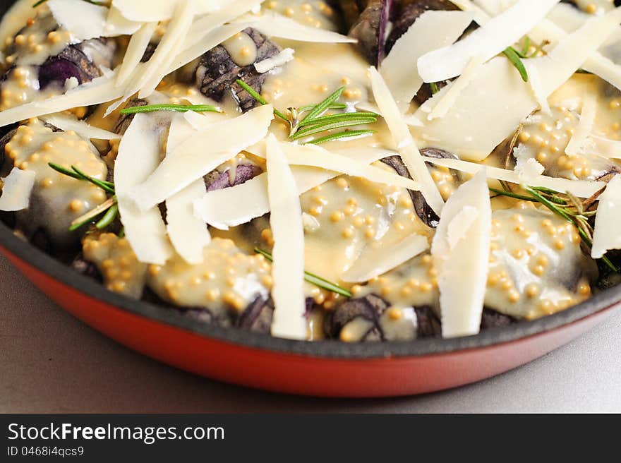 Violet potatoes with mustard sauce, rosemary and parmigiana