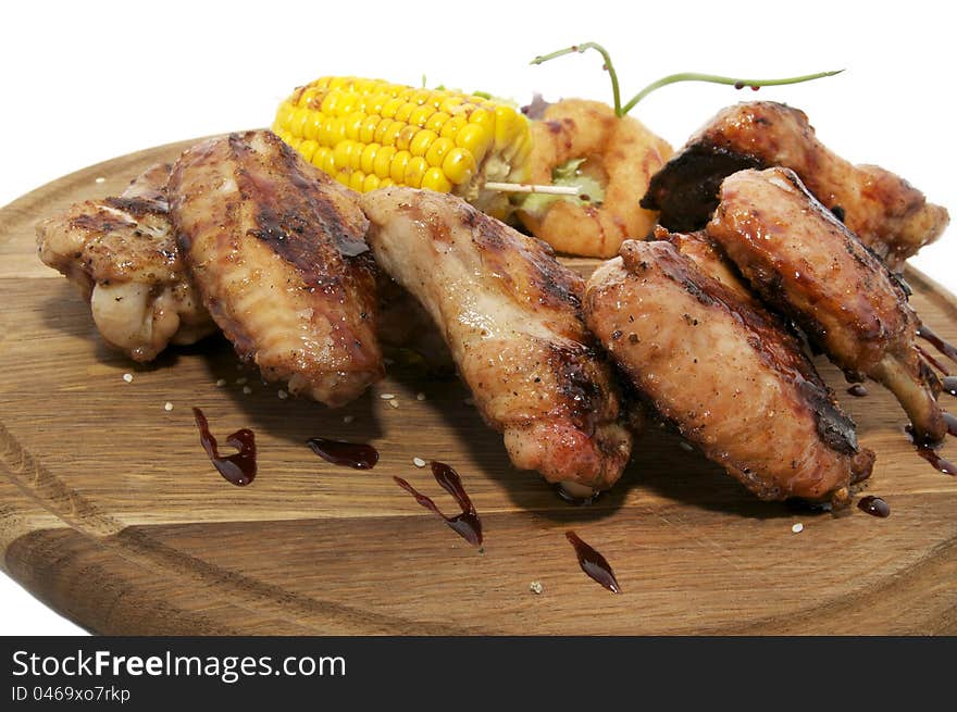 Chicken wings grilled with vegetables and corn. Chicken wings grilled with vegetables and corn