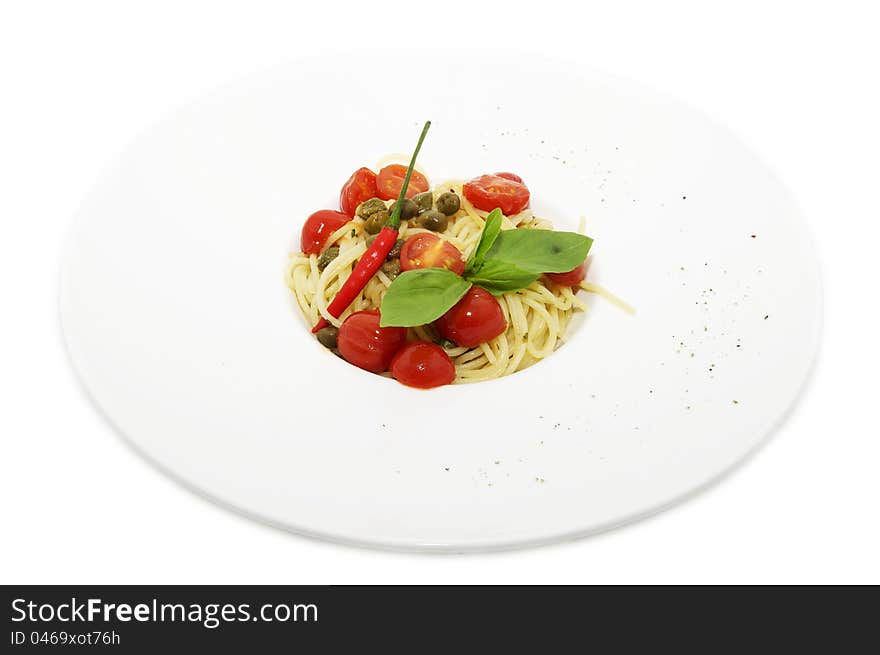 Pasta with tomato and pepper on a plate on a white background. Pasta with tomato and pepper on a plate on a white background